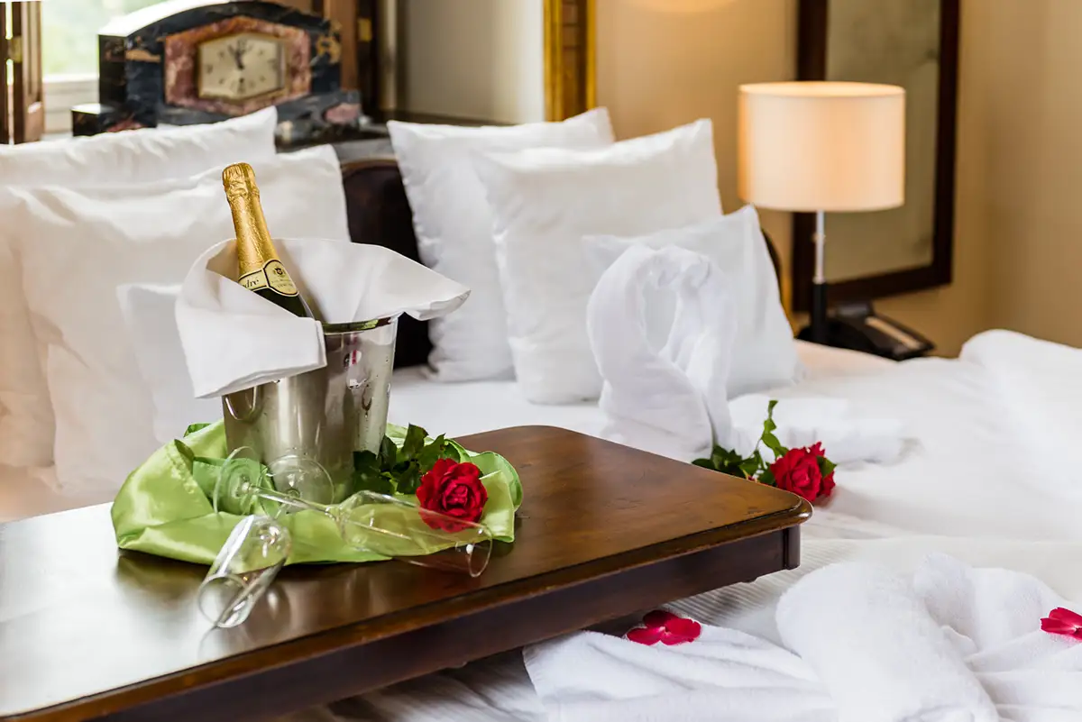 Breakfast tray with a flower on the bed