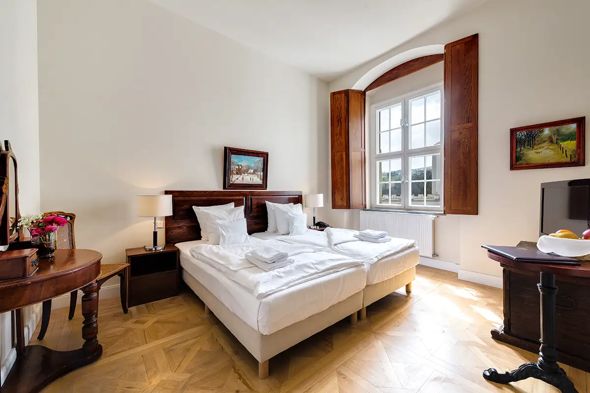 Bedroom with double bed and floor-to-ceiling windows